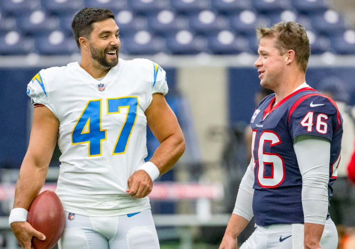 Long snappers Joe Harris of the Chargers and Jon Weeks of the Texans talk before a game.